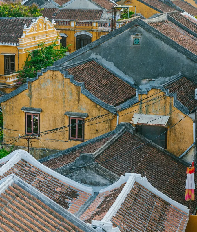Tiled roofs and yellow merchant houses of Hoi An old town, seen from above
